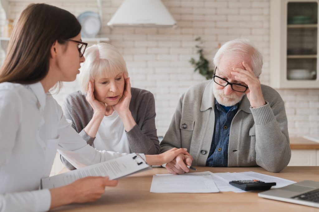 Emotional mental support. Financial adviser consulting senior elderly grandparents showing debts