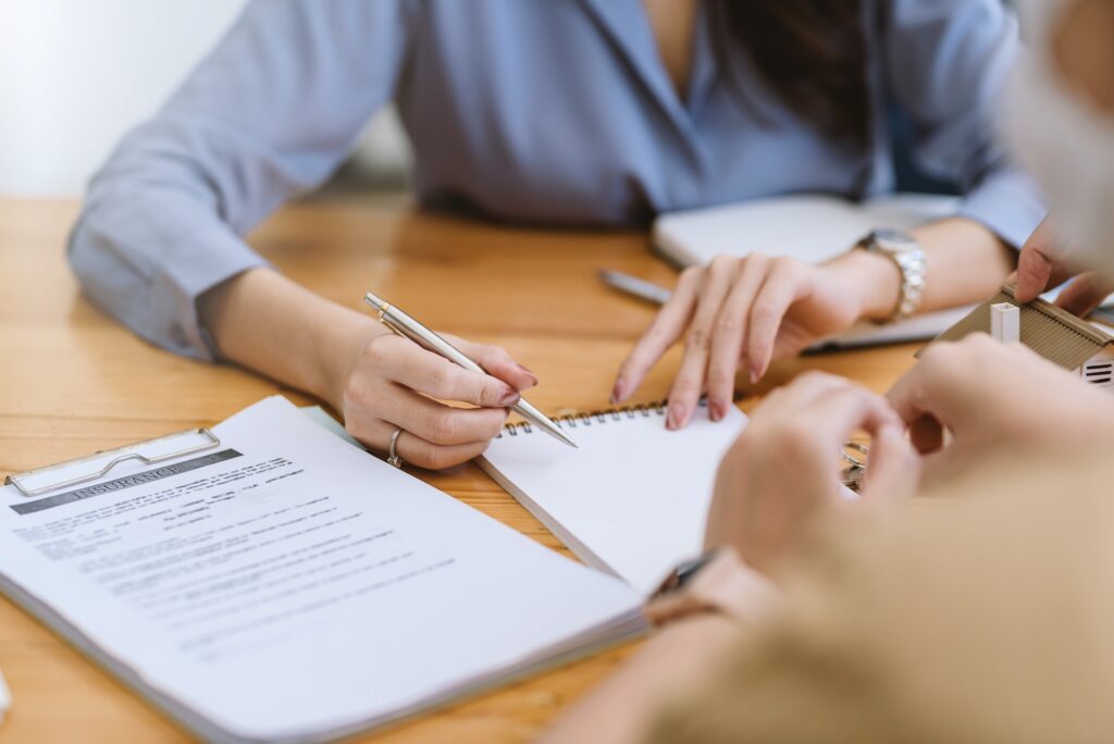 Female insurance agents are offering insurance to customer.