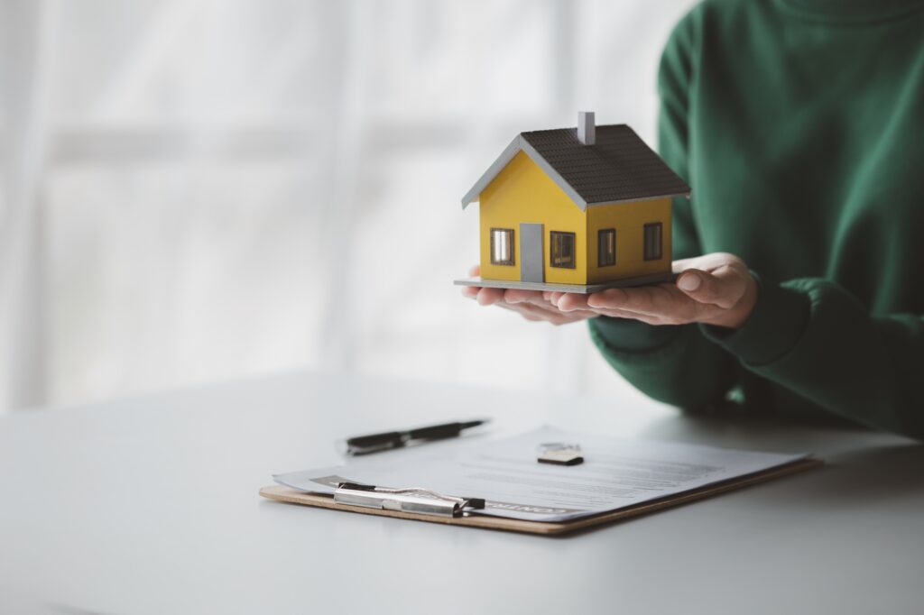 The salesperson of the housing estate in the project is preparing and verifying the contract of sale